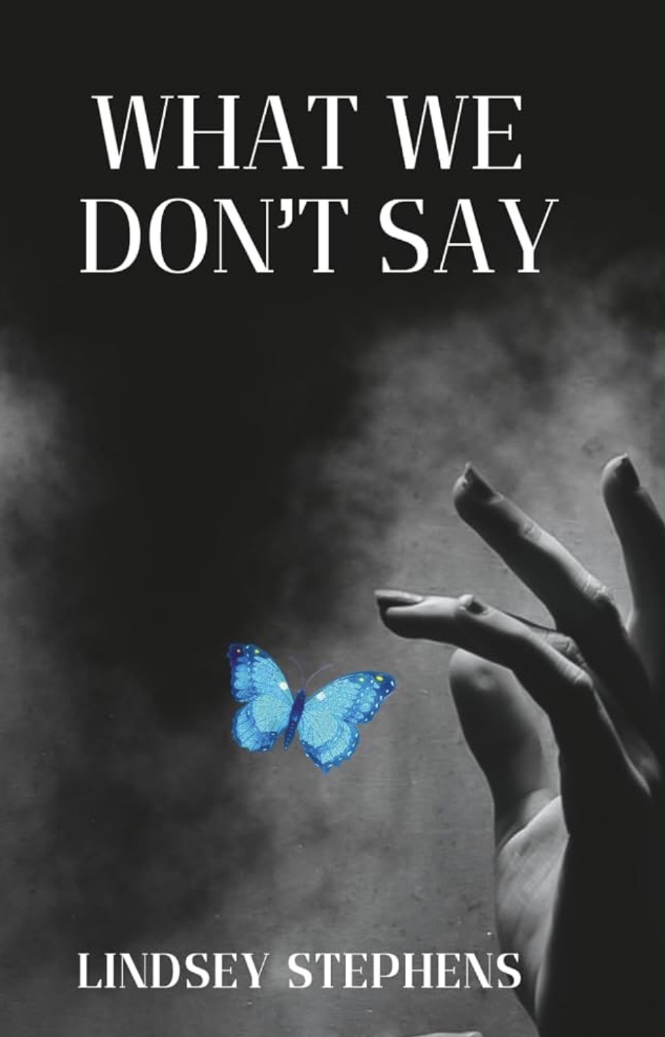 What We Don’t Say book cover, black and white with a vivid blue butterfly